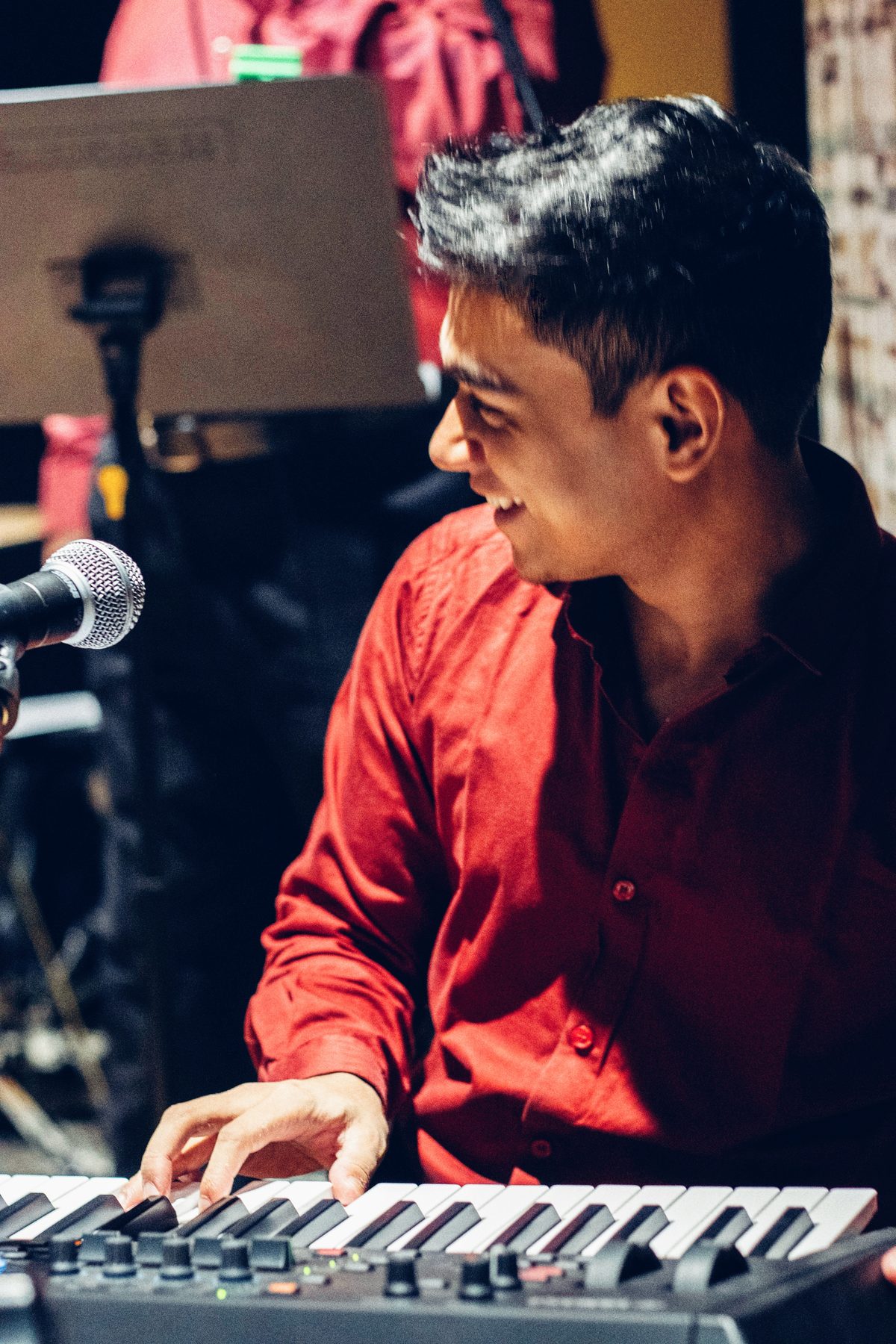 Kenn smiling at the keyboard during a live set
